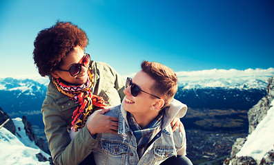 Image showing happy teenage couple in shades having fun outdoors