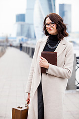 Image showing smiling middle-aged woman with books