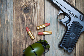 Image showing handgun with cartridges and grenade