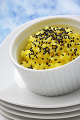 Image showing Rice (boiled with curcuma) and black sesame topping