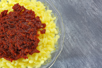 Image showing Rice (boiled with curcuma) and harissa sauce
