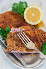 Image showing Piece of beef schnitzel on a fork.