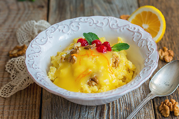 Image showing Bowl with millet porridge, lemon cream and nuts.
