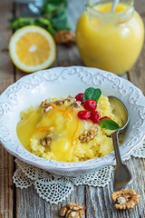 Image showing Cup of porridge of millet, berries, nuts and lemon cream.