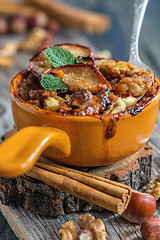 Image showing Ceramic bowl of oatmeal baked with apple and cinnamon.