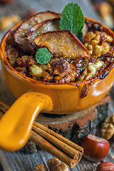 Image showing Oatmeal with apples, cinnamon and nuts closeup.