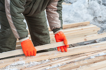 Image showing Carpenter working at sawmill 