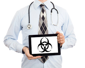 Image showing Doctor holding tablet - Warning! Biohazard!