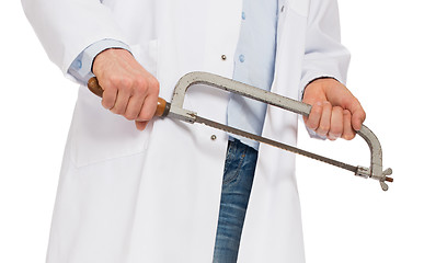 Image showing Crazy doctor is holding a big saw in his hands