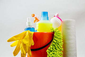 Image showing Bucket with cleaning items on light background