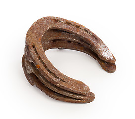 Image showing Stack of old rusty horseshoes