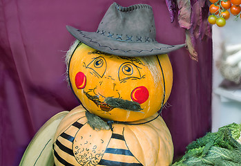 Image showing Funny statue made from two pumpkins in the form of a man in a ha