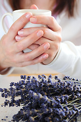 Image showing Hands holding a cup