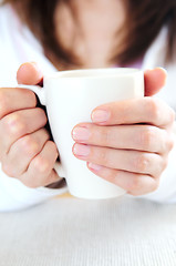 Image showing Hands holding a cup