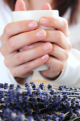 Image showing Hands holding a cup