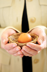 Image showing Hands holding nest with egg