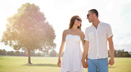 Image showing happy smiling couple walking over summer park