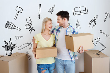 Image showing smiling couple with big boxes moving to new home