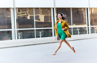 Image showing happy young woman or teenage girl on city street