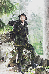 Image showing young soldier with backpack in forest