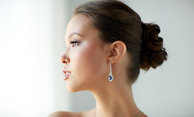 Image showing close up of beautiful woman face with earring