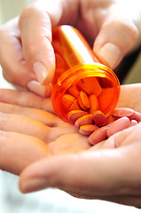 Image showing Hands holding pills