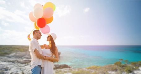 Image showing smiling couple with air balloons outdoors