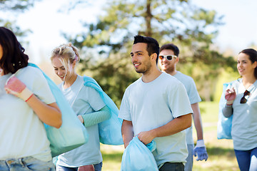 Image showing group of volunteers with garbage bags in park