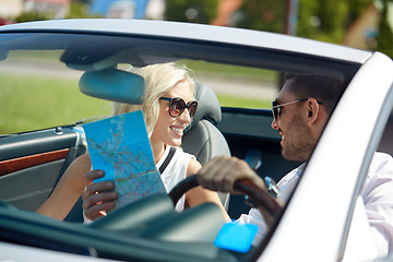 Image showing happy man and woman with map in cabriolet car
