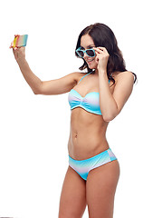 Image showing woman in swimsuit taking selfie with smatphone