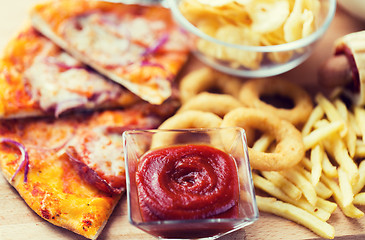 Image showing close up of fast food snacks on wooden table