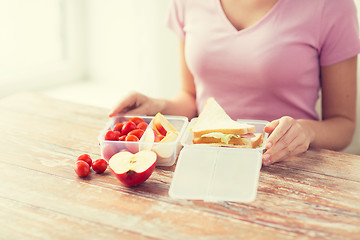 Image showing close up of woman with food in plastic container