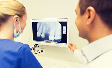 Image showing close up of dentist and assistant at dental clinic