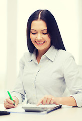 Image showing businesswoman or student working with calculator