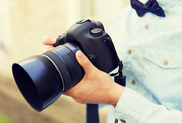 Image showing close up of male photographer with digital camera