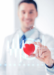 Image showing male doctor with heart and cardiogram