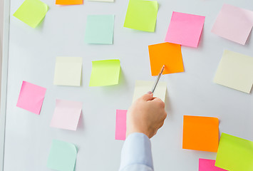 Image showing close up of hand pointing to sticker on flip chart