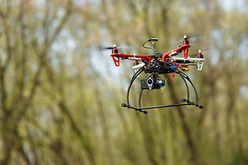 Image showing Quadrocopter while flying in the forest. 