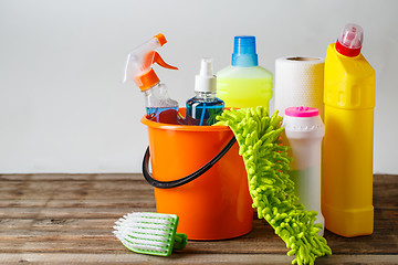 Image showing Bucket with cleaning items on light background