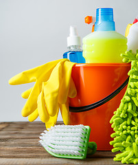 Image showing Bucket with cleaning items on light background