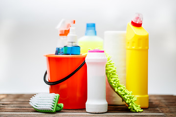 Image showing Bucket with cleaning items on light background