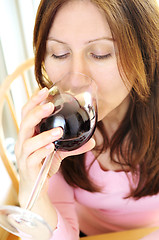 Image showing Mature woman with a glass of red wine