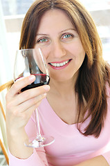 Image showing Mature woman with a glass of red wine