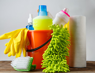 Image showing Bucket with cleaning items on light background