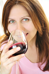 Image showing Mature woman with a glass of red wine