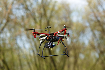 Image showing Quadrocopter while flying in the forest. 