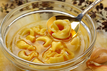 Image showing Freshly boiled tortellini in glass bowl with broth