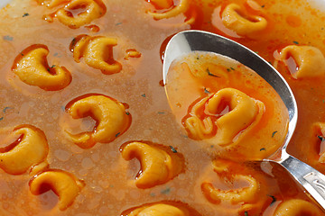 Image showing Freshly boiled tortellini in glass bowl with spicy broth