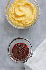 Image showing Hummus and harissa sauce on painted textile background