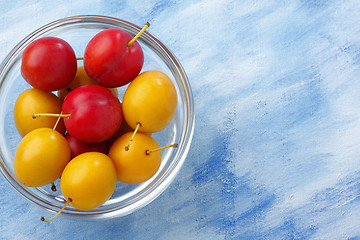 Image showing Glass bowl filled by yellow and red mirabelle plums